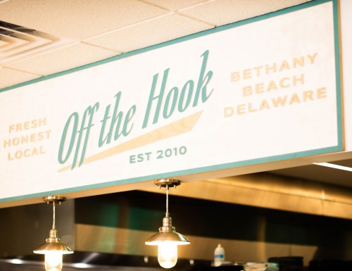 Sign for "Off the Hook" restaurant, established 2010, located in Bethany Beach, Delaware, with a fresh and local theme.