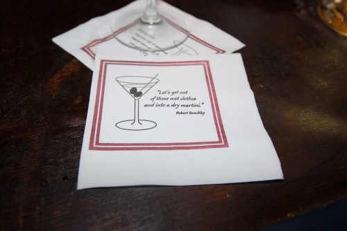 A cocktail napkin featuring a martini illustration and a quote by Robert Benchley about dry martinis.