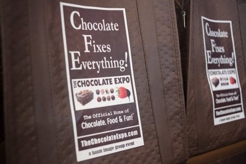 A poster promoting "The Chocolate Expo" with the slogan "Chocolate Fixes Everything!" and event details.