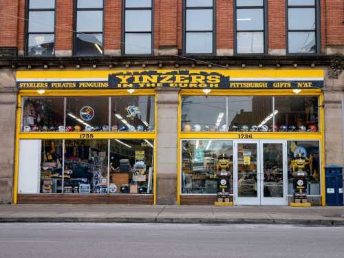 Storefront of "Yinzers in the Burgh" featuring Pittsburgh sports merchandise and gifts, with yellow and black signage.