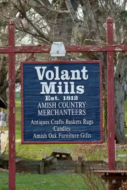 Sign for Volant Mills, established in 1812, featuring Amish country merchandise like antiques, crafts, and furniture gifts.