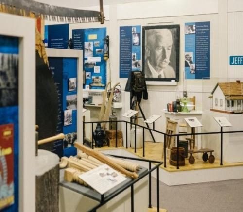 A museum exhibit featuring historical artifacts, photographs, and informational displays about local history.