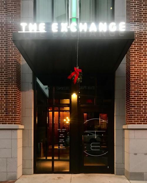 Entrance of "The Exchange" with festive decor, featuring a mistletoe hanging above the door.