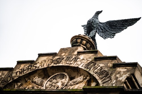 A close-up of the Soldiers and Sailors Monument, featuring an eagle statue atop a stone structure.