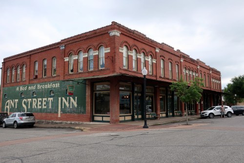 Historic brick building with "Ant Street Inn" sign, featuring large windows and a charming bed and breakfast atmosphere.
