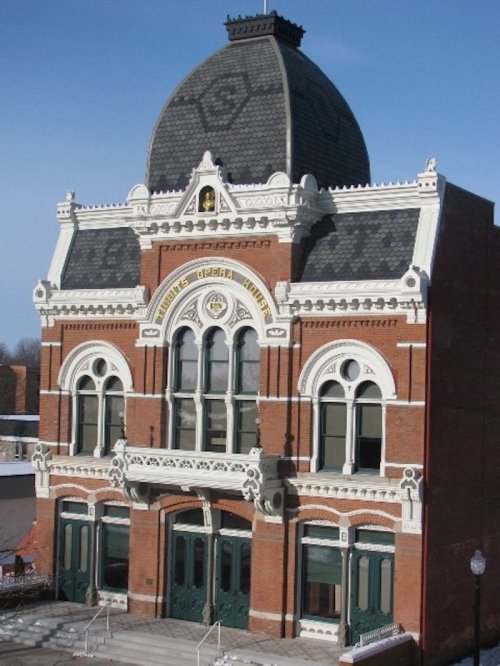 Historic brick building with ornate architecture and a large dome, featuring decorative details and arched windows.
