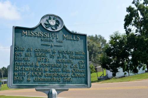 Historical marker for Mississippi Mills, detailing its establishment, operations, and closure dates.