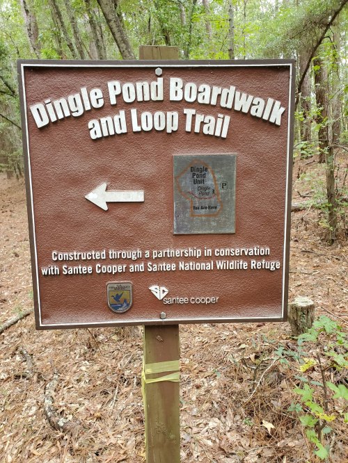 Sign for Dingle Pond Boardwalk and Loop Trail, with directions and information about conservation partnerships.