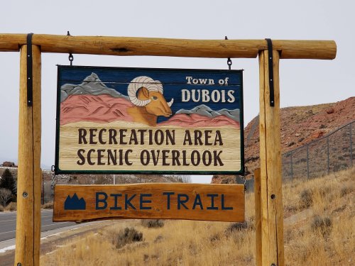 Sign for the Town of Dubois, indicating a recreation area and scenic overlook, with a bike trail below.