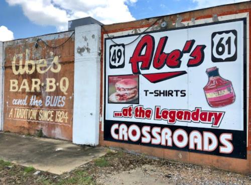 Mural featuring "Abe's Bar-B-Q" and "Abe's T-Shirts" at the Legendary Crossroads, with vintage-style graphics.