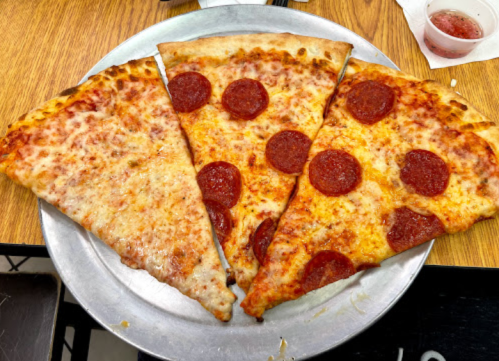 Three slices of pizza on a metal plate: one cheese, one pepperoni, and one with extra cheese and pepperoni.