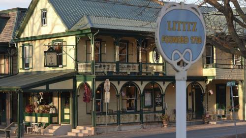A historic building in Lititz, Pennsylvania, with a sign indicating the town was founded in 1756.