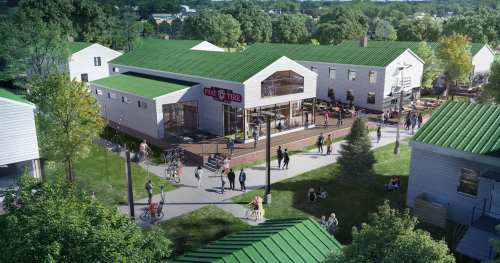 Aerial view of a modern community space with green roofs, outdoor seating, and people enjoying the area.
