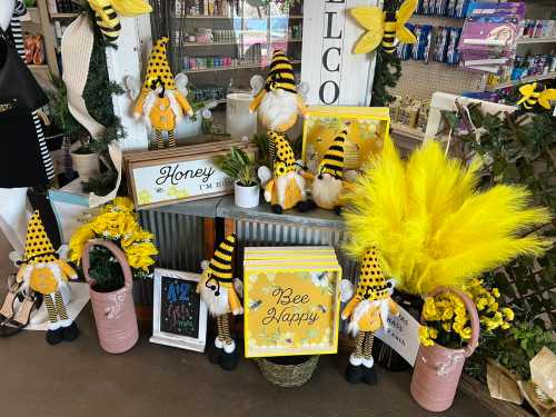 A colorful display featuring yellow and black bee-themed decorations, including plush figures and flowers.