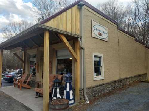 A rustic cheese shop with a wooden porch, featuring benches and decorative lighthouses outside.