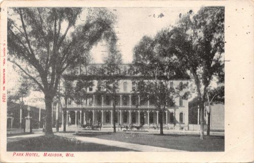 Black and white postcard of the Park Hotel in Madison, Wisconsin, surrounded by trees and a grassy area.