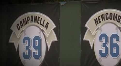 Banners displaying the numbers 39 (Campanella) and 36 (Newcombe) on a baseball field backdrop.