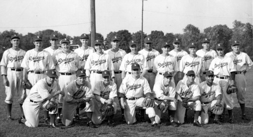 A vintage black-and-white photo of a baseball team, the Dodgers, posing together on a field.