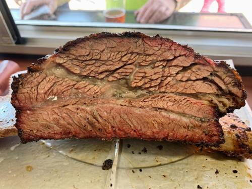 Close-up of a perfectly smoked brisket, showcasing its juicy, marbled texture and smoky crust.