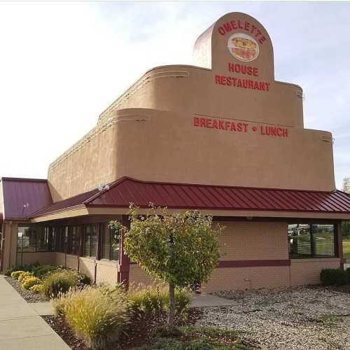 Exterior of Omelette House Restaurant, featuring a distinctive architectural design and signage for breakfast and lunch.