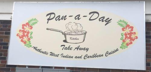 Sign for "Pan-a-Day" Take Away, featuring a pot and flowers, promoting authentic West Indian and Caribbean cuisine.