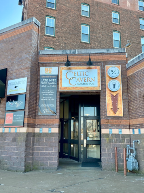 Entrance to Celtic Cavern Gastro Pub, featuring signage and brick building exterior.