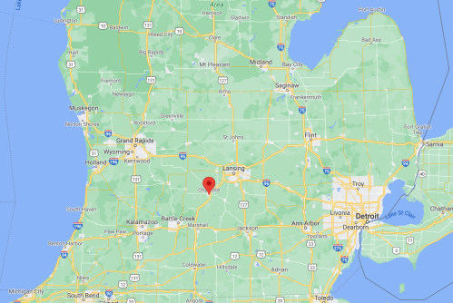 Map of Michigan highlighting Lansing with a red marker, surrounded by green areas and major highways.
