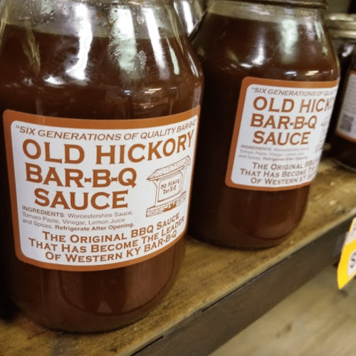 Two jars of Old Hickory Bar-B-Q Sauce on a shelf, showcasing the label and ingredients.