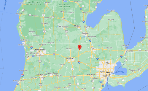 Map showing central Michigan with a red marker indicating Lansing, near major highways and surrounding cities.