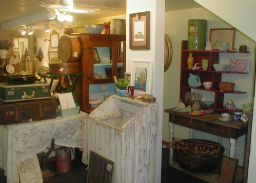 A cozy vintage shop filled with various antiques, including furniture, decor, and collectibles on display.