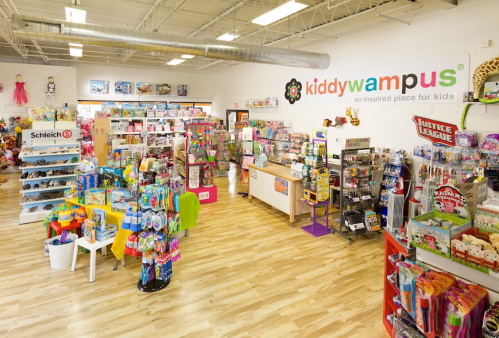 Brightly lit children's store filled with toys, games, and colorful displays, featuring a welcoming atmosphere.