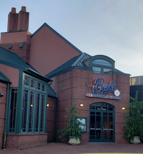 Exterior of Banks Seafood Kitchen, featuring a brick facade and large windows, with a sign above the entrance.