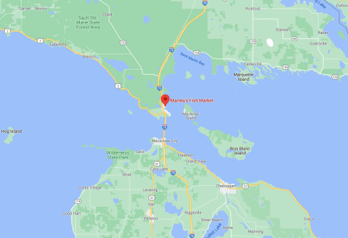 Map showing Manley's Fish Market located near Mackinaw City, Michigan, with surrounding lakes and parks.