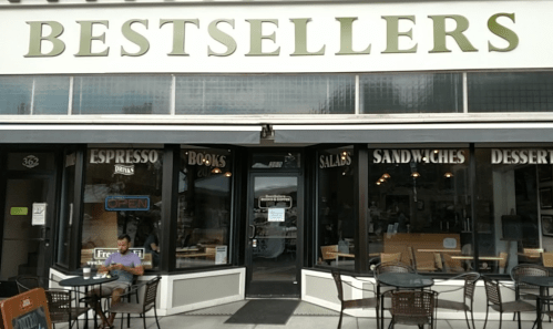 A storefront labeled "Bestsellers" featuring outdoor seating and signs for espresso, books, salads, sandwiches, and desserts.