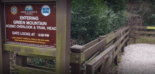 Sign at the entrance to Green Mountain Scenic Overlook and Trail Head, with information about gate locks at 6 PM.