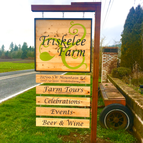 Sign for Triskelee Farm with details about farm tours, celebrations, events, and offerings of beer and wine.