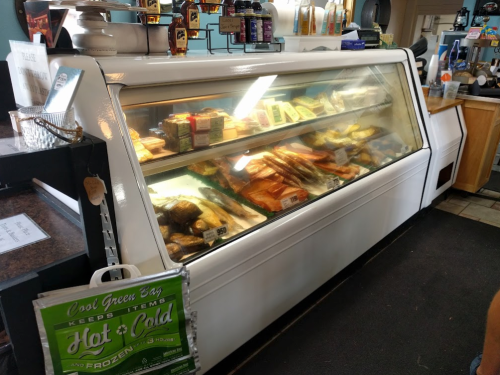 A display case filled with various seafood and food items in a casual dining setting.