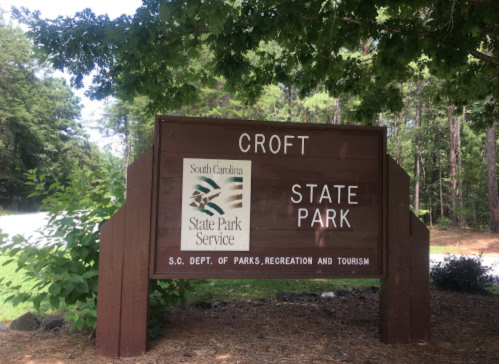 Sign for Croft State Park in South Carolina, featuring the state park service logo and information about the park.