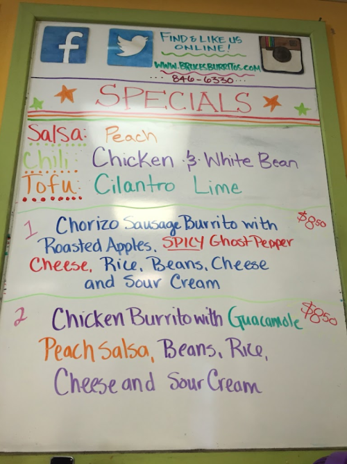 Whiteboard menu listing specials: Peach Salsa, Chicken & White Bean, Chorizo Burrito, and Chicken Burrito with Guacamole.