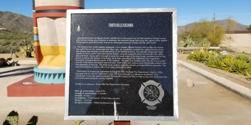 A plaque detailing the history and significance of Tohono O'odham culture, set against a desert landscape.