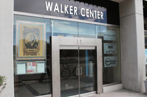 Entrance of the Walker Center featuring large glass doors and a sign above with the name "WALKER CENTER."