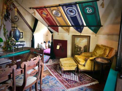Cozy room with a yellow armchair, a dining table, and house banners hanging from the ceiling, adorned with rugs and artwork.
