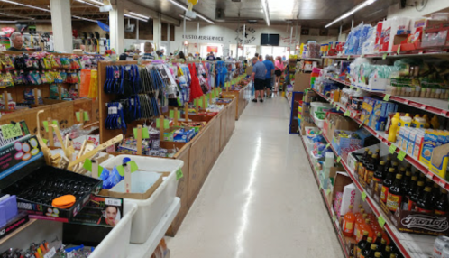 A busy store aisle filled with colorful merchandise, including snacks, household items, and personal care products.