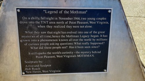 Plaque about the Mothman legend, detailing its origins and ongoing curiosity surrounding the mystery in Point Pleasant, WV.