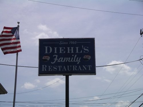 Sign for Diehl's Family Restaurant, established in 1960, with an American flag in the background.