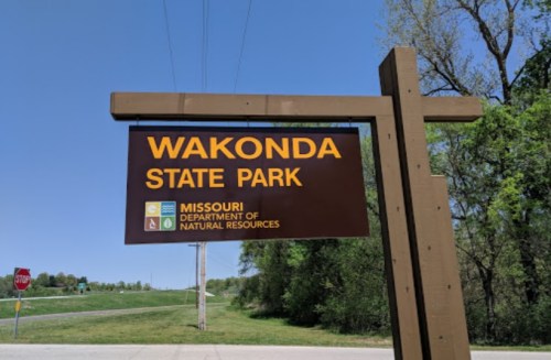 Sign for Wakonda State Park in Missouri, featuring park symbols and the Department of Natural Resources logo.