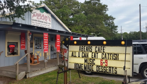 Abeare's Café exterior with a sign advertising all-you-can-eat catfish, music, and homemade desserts.