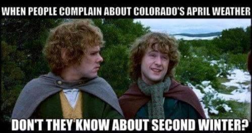 Two characters in cloaks stand in a snowy landscape, with text humorously referencing Colorado's unpredictable April weather.