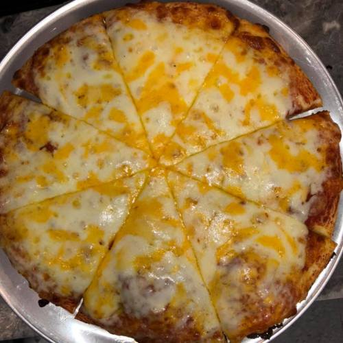 A round pizza with a golden crust, topped with melted cheese, sliced into eight equal pieces.