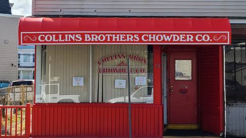 Red storefront with a sign reading "Collins Brothers Chowder Co." and large windows.